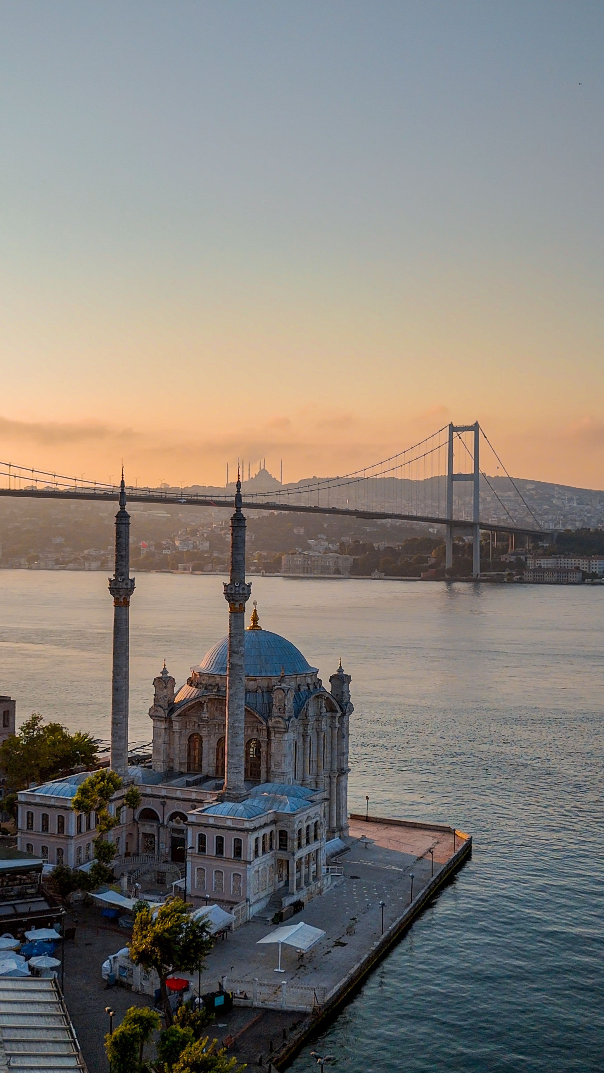 Aerial View of Ortakoy Mosque and Bosphorus Bridge at Sunrise in Istanbul, Cultural and Historical Legacy of Istanbul: Ortaköy Mosque and Bosphorus Scenery, Harmony of Sea and Sky: Peaceful Morning in Istanbul